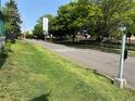 View of a street lined with trees and green grass, and a painted crosswalk at 4047 Lowell Blvd, Denver, CO 80211