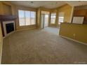 Bright living room with neutral walls, fireplace, and large windows offering ample natural light at 8520 S Holland Ln # 302, Littleton, CO 80128