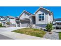 Beautiful home featuring a two-car garage, well-maintained lawn, and picturesque curb appeal at 5925 La Posada Pl, Parker, CO 80134
