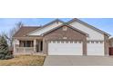 Charming exterior of this two-story home featuring a brick facade and a spacious two-car attached garage at 11237 W 55Th Ln, Arvada, CO 80002