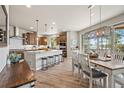 Eat-in kitchen features an island with bar seating, stainless steel appliances and wooden cabinets at 16231 Thunder Cat Way, Monument, CO 80132