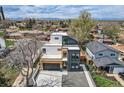 Modern two-story home with mixed material exterior, large windows and stylish landscaping in a neighborhood setting at 1655 Wolff St, Denver, CO 80204