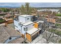 Stunning contemporary home featuring white and wood exterior with rooftop deck and mountain views at 1655 Wolff St, Denver, CO 80204