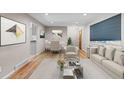 Inviting living room featuring neutral paint, lots of natural light and wood floors at 8305 Eaton Way, Arvada, CO 80003