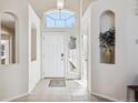 Inviting foyer with arched window, tiled flooring, and recessed niche perfect for decor at 24783 E Arkansas Pl, Aurora, CO 80018