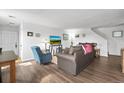 Cozy living room with hardwood floors, neutral walls, and comfortable seating, creating a welcoming atmosphere at 892 Macaw St, Brighton, CO 80601