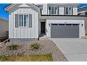 Inviting home exterior features a dark front door, and a gray garage door at 9175 Uravan Ct, Commerce City, CO 80022