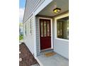 Inviting front entryway with a red door and stylish welcome mat at 1405 S Utica St, Denver, CO 80219