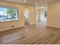 Bright living room featuring hardwood floors, neutral paint, and abundant natural light at 1405 S Utica St, Denver, CO 80219