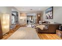 Bright living room with hardwood floors, modern furnishings, and access to the backyard at 4011 S Ivy Ln, Cherry Hills Village, CO 80111