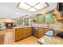 Bright kitchen with granite countertops, stainless steel appliances, and a view of the living room at 6222 S Ames Ct, Littleton, CO 80123
