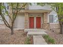 Close up view of the dual red front doors with stone and beige columns at 9300 E Florida Ave # 906, Denver, CO 80247