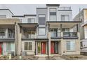 New townhome community with modern facade, balconies, and eye-catching red front doors at 1755 Peak Loop, Broomfield, CO 80023