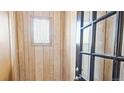 Inviting entryway with wood-paneled walls, decorative window, and stylish glass-paneled door at 553 N Logan St, Denver, CO 80203