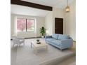 Bright living room featuring large windows, modern furniture, and stylish decor at 8133 W Quarto Ave, Littleton, CO 80128