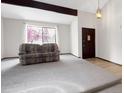 Inviting living room with a large window, plush carpet, and a cozy atmosphere at 8133 W Quarto Ave, Littleton, CO 80128