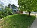 Well-manicured lawn and mature trees enhance the curb appeal of this home at 3136 S Cathay Cir, Aurora, CO 80013