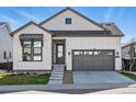 Charming two-story home with a gray garage door and gray trim, complemented by a well-manicured lawn at 11492 Stonewash St, Littleton, CO 80125