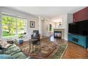 Cozy living room featuring a fireplace, hardwood floors, and lots of natural light at 2550 Winding River Dr # E1, Broomfield, CO 80023