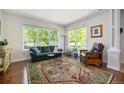 Bright living room with large windows, hardwood floors, and stylish furniture at 2550 Winding River Dr # E1, Broomfield, CO 80023