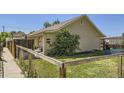 Exterior showcasing the fenced yard, landscaping, and charming architecture of the home at 2841 N Columbine St, Denver, CO 80205