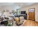 Well-lit living room with an entertainment center, hardwood floors, and open access to other living areas at 2841 N Columbine St, Denver, CO 80205
