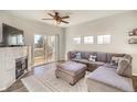 Spacious living room with a fireplace, plush sectional sofa, and access to a private balcony at 9335 Amison Cir # 203, Parker, CO 80134