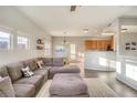 Bright, open-concept living area featuring a comfortable sectional sofa and adjacent dining space at 9335 Amison Cir # 203, Parker, CO 80134