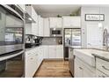 Modern kitchen with white cabinets, granite countertops, and a farmhouse sink at 20150 E Fair Ln, Centennial, CO 80016