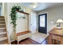 Warm entryway with hardwood floors, coat rack, and decorative details to welcome you home at 13915 W 73Rd Ave, Arvada, CO 80005