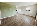 Spacious living room with hardwood flooring, light walls, and ample natural light from the windows at 1170 Elmira St, Aurora, CO 80010