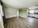 Inviting living room showcasing hardwood flooring and open layout with a view into the kitchen at 1170 Elmira St, Aurora, CO 80010