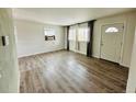 Bright living room featuring hardwood floors, fresh paint, and large windows for natural light at 1170 Elmira St, Aurora, CO 80010