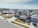 Two-story home with two-car garage, professionally landscaped yard, and community view at 6977 Copper Sky Cir, Castle Pines, CO 80108