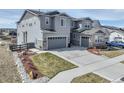 Two-story home with a two-car garage and landscaped front yard at 6977 Copper Sky Cir, Castle Pines, CO 80108