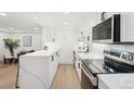 Bright kitchen with quartz countertops, stainless steel appliances, and an adjacent dining area at 252 N Pennsylvania St # 102, Denver, CO 80203