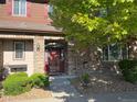 Charming townhome exterior with brick accents, well-maintained landscaping, and a striking red front door at 11307 Navajo Cir # A, Westminster, CO 80234