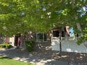 Well-maintained townhome featuring stone accents, tasteful landscaping, and a red front door at 11307 Navajo Cir # A, Westminster, CO 80234