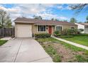 Inviting single-story home with attached garage, manicured landscaping, and charming red front door at 4906 E Bates Ave, Denver, CO 80222