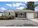 Charming single-story home featuring a well-maintained front yard, attached garage, and welcoming curb appeal at 1920 Elmira St, Aurora, CO 80010
