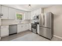 Modern kitchen with stainless steel appliances, white cabinets, granite countertops and subway tile backsplash at 1920 Elmira St, Aurora, CO 80010