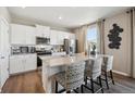 Modern kitchen with granite countertops, stainless steel appliances, and a stylish breakfast bar at 4331 Gypsum Ave, Mead, CO 80504