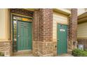 Close-up of the entrance doors, showing the brick and stone construction at 3866 S Dallas Cir # 12202, Aurora, CO 80014