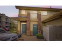 Inviting condo exterior featuring a mix of brick and siding, plus a small balcony at 3866 S Dallas Cir # 12202, Aurora, CO 80014