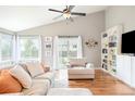 Comfortable living room with vaulted ceiling, built-in shelving, and abundant natural light at 577 Tristan Pl, Berthoud, CO 80513