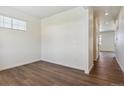 Bright, empty bedroom with wood floors and a neutral color scheme creates a relaxing space at 1836 Westport Ave, Berthoud, CO 80513