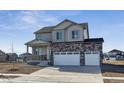 Charming two-story home with a stone and vinyl exterior, three car garage, and a covered front porch at 1836 Westport Ave, Berthoud, CO 80513