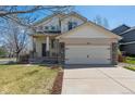 Two-story home featuring a two-car garage, manicured lawn, and inviting curb appeal at 10806 Crooke Dr, Parker, CO 80134