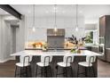 Modern kitchen with white and wood cabinets, and center island at 7036 E Archer Pl, Denver, CO 80230