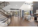 Open living space with hardwood floors and a modern fireplace at 7036 E Archer Pl, Denver, CO 80230